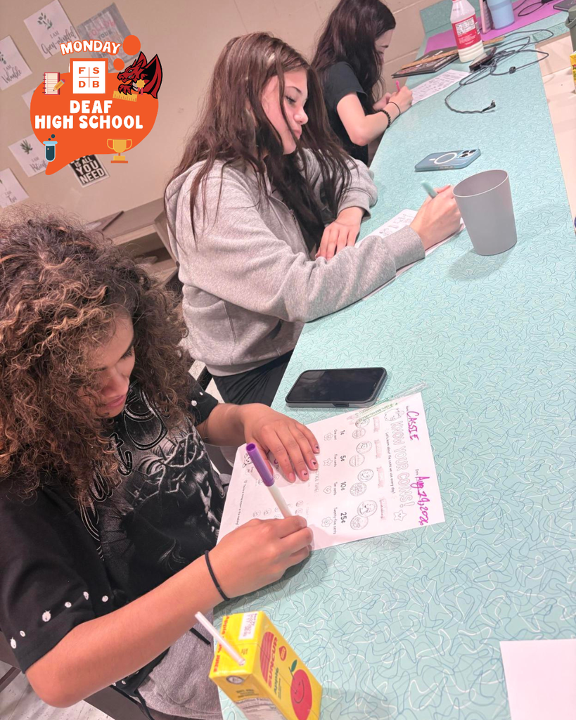 Three students are working on a counting coins paper inside James Hall.