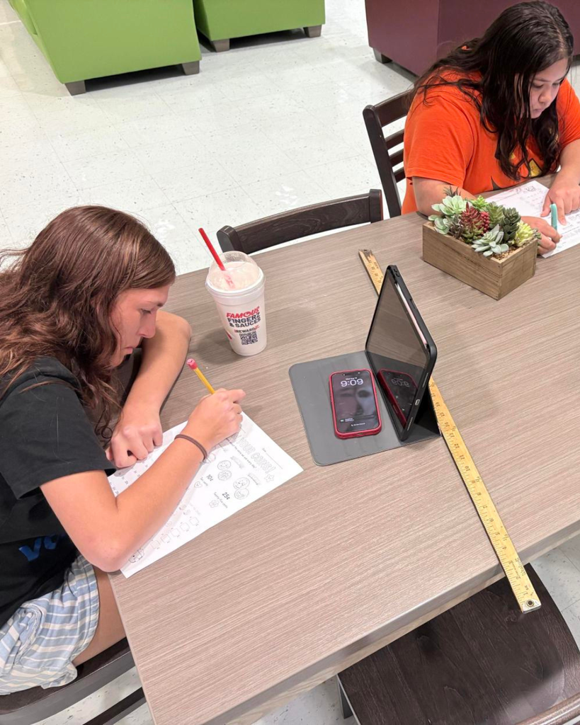Students working on counting coins paper inside James Hall.