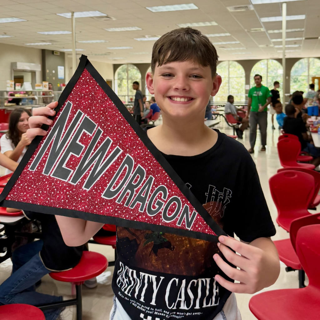 A student holds the "New Dragon" flag. 