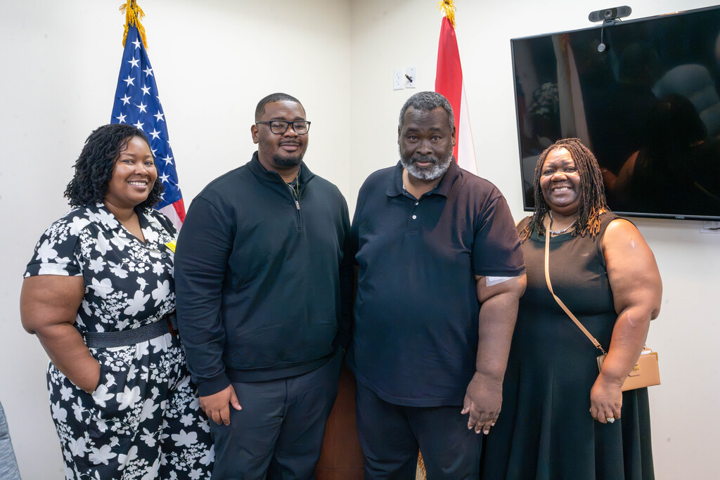 Ne'Darrius smiles for a photo with his family inside the police campus building