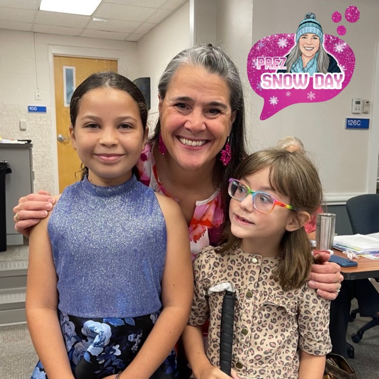 Zenia, President Snow and Sylvia pose together in the Board of Trustee meeting room. 