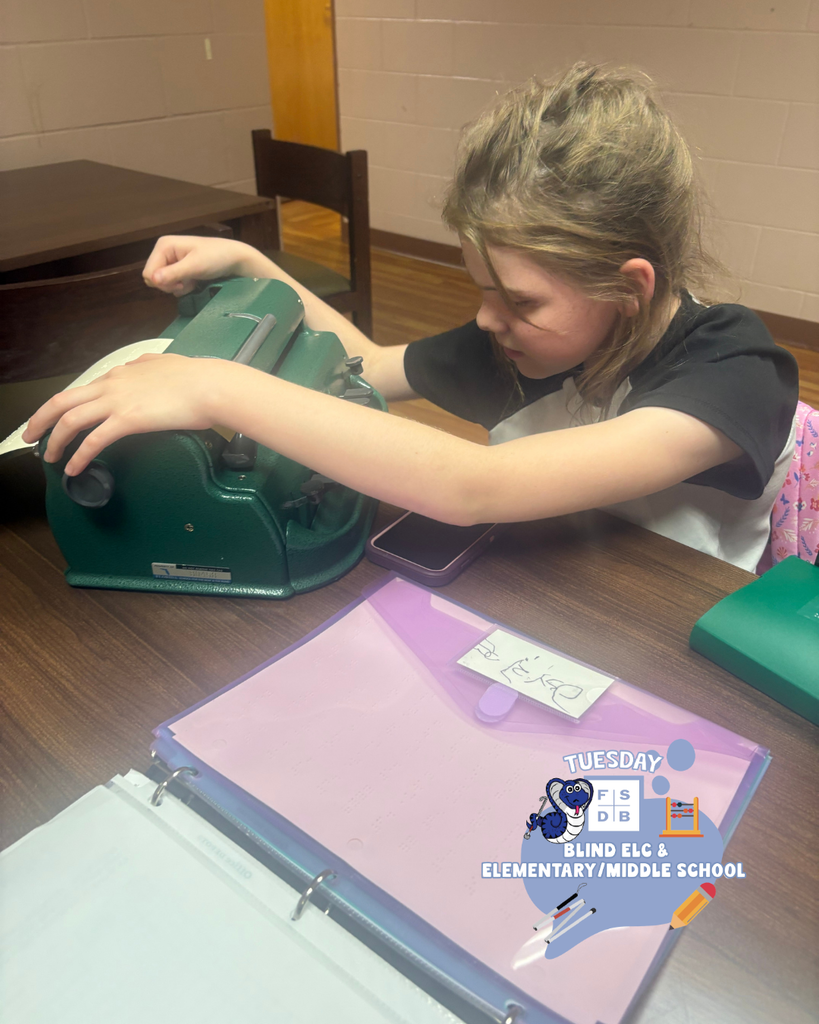 A student is working on a braille machine. 