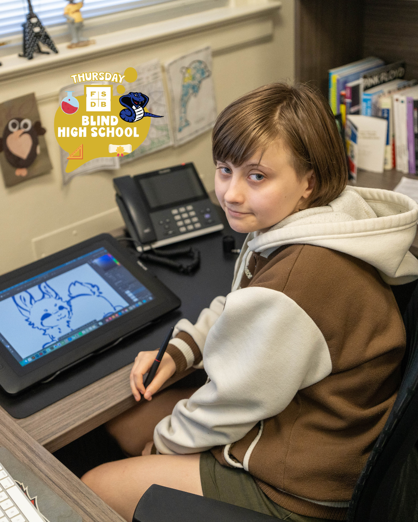 Blind student smiles for her photo with the design she is creating inside the Communication office.