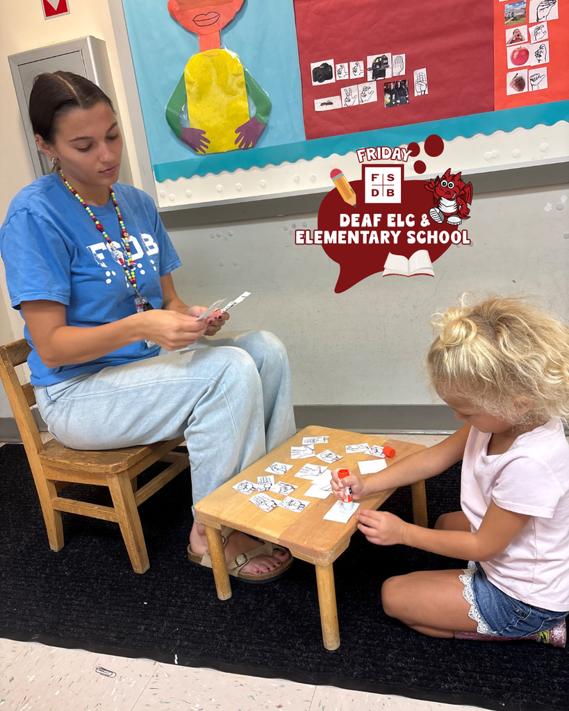 ELC teacher helps a student with glueing inside the classroom. 