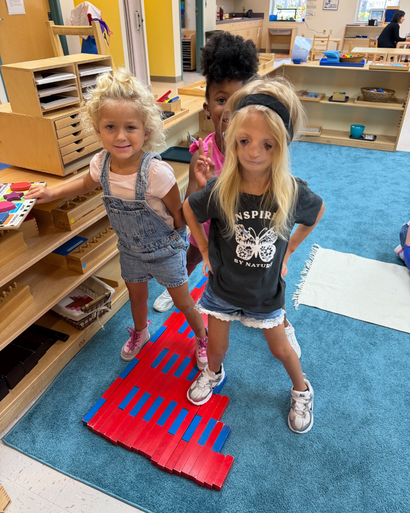 Two students smile for a photo inside the classroom. 