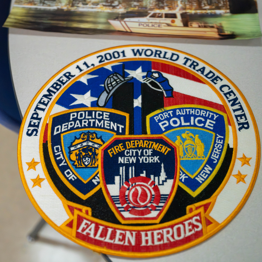 A badge that says "September 11,2001 World Trade Center , Fallen Heroes" 
