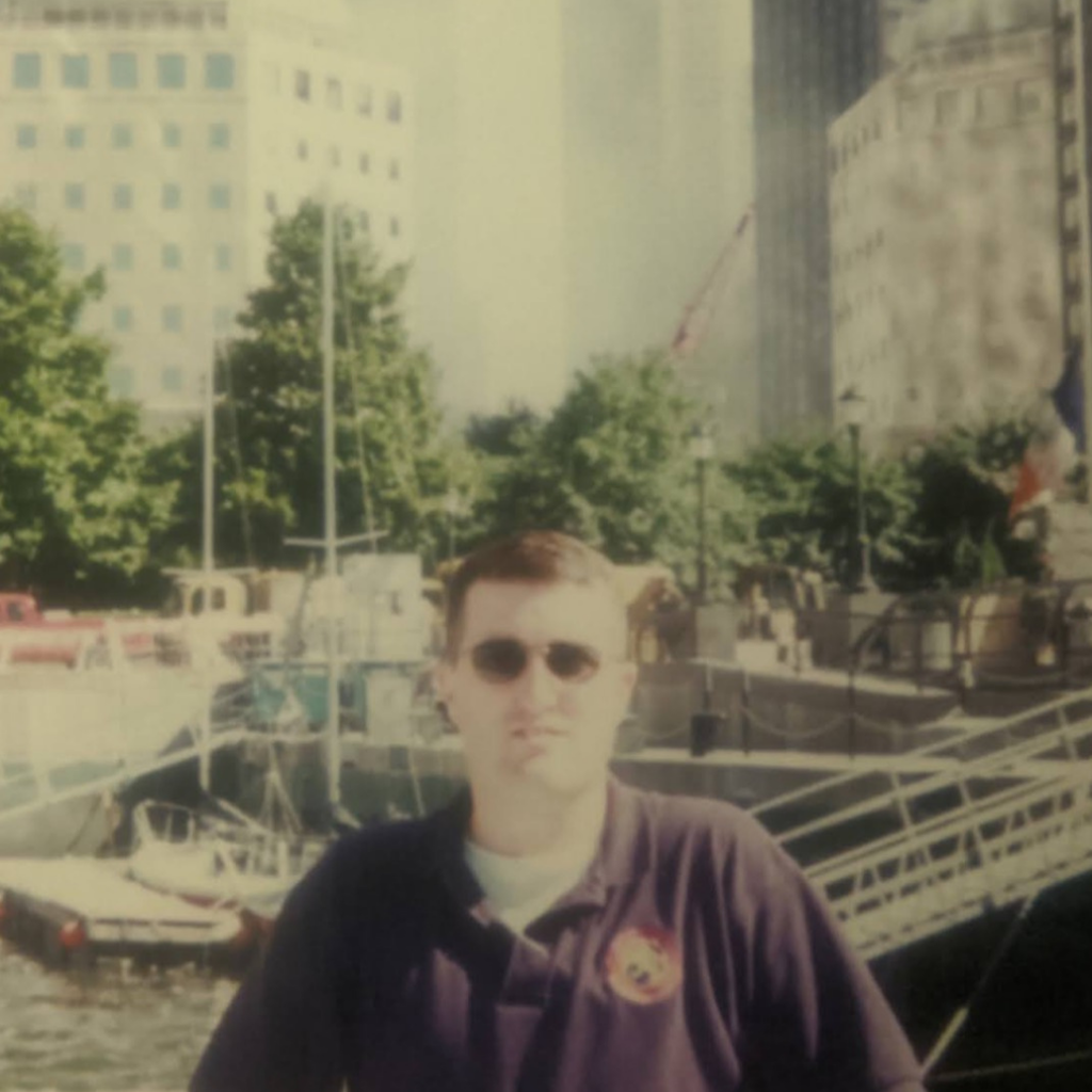 Photo of Mr. Ward in New York with the Towers in the background.