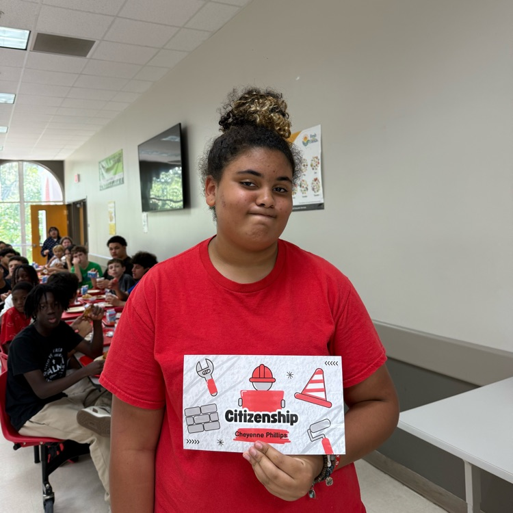 A students holds her Citizenship Award.