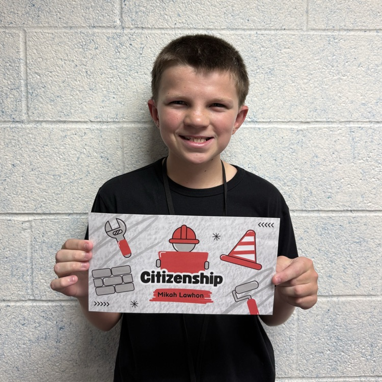 A students holds his Citizenship Award.