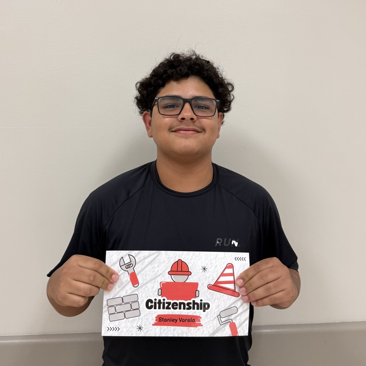 A student holds his Citizenship Award.
