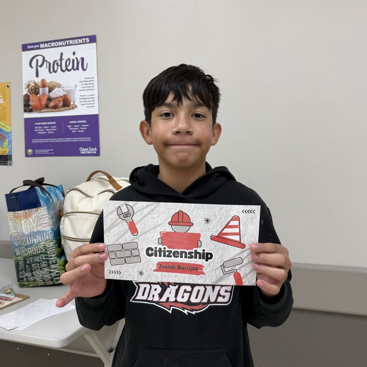 A student holds his Citizenship Award.