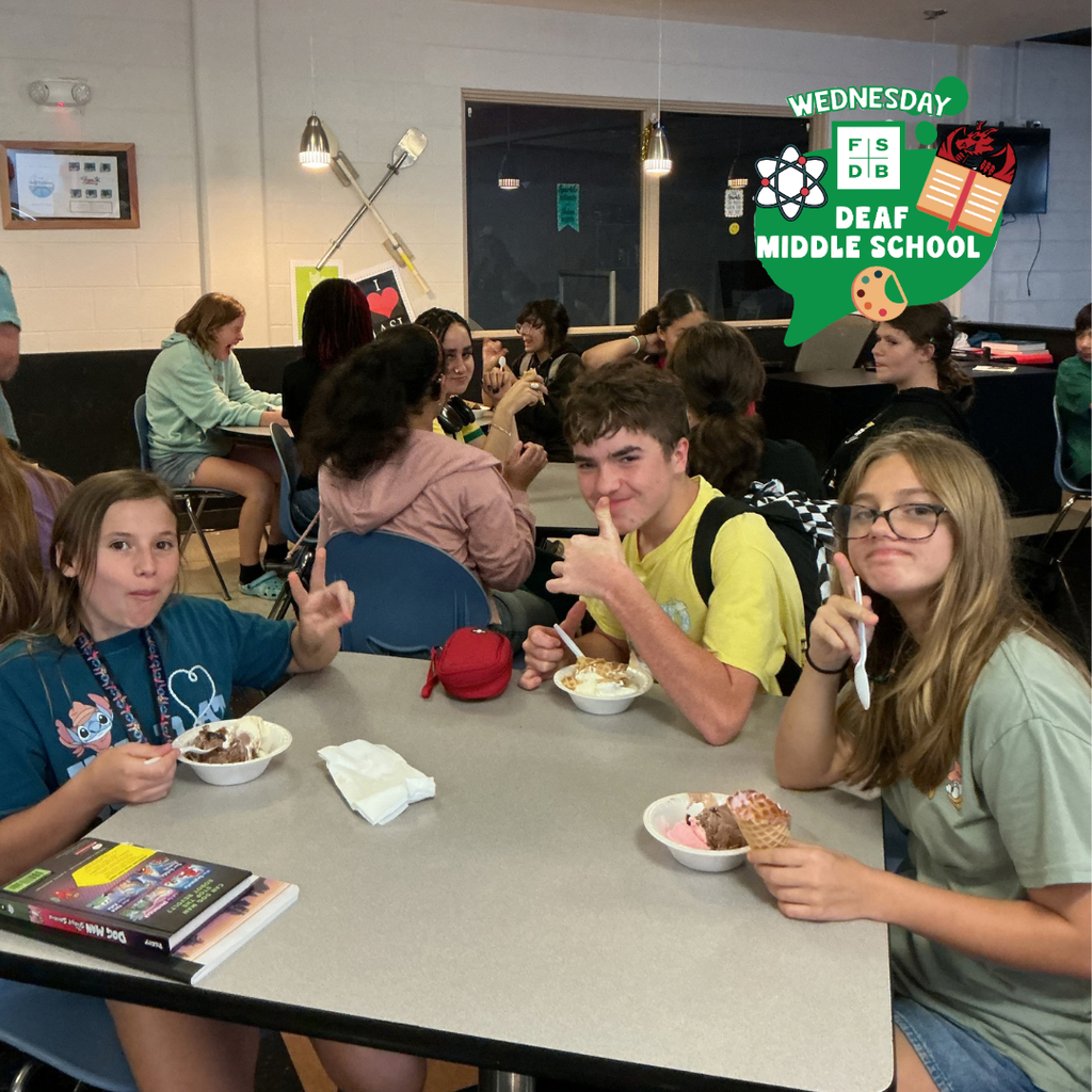 Group of students smile for their photo with ice cream inside the DL. 