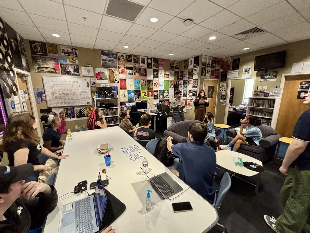 Students sitting in the media room watching a presentation.