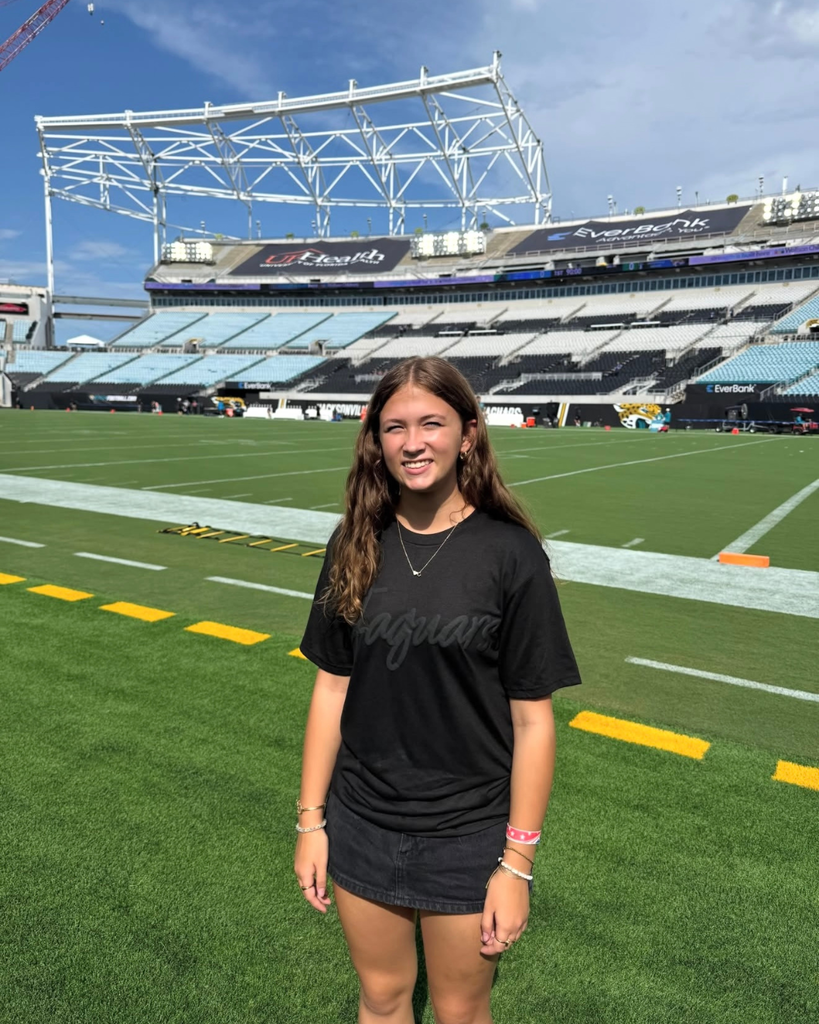 A deaf high school senior smiles on the field of Jacksonville Jaguars.
