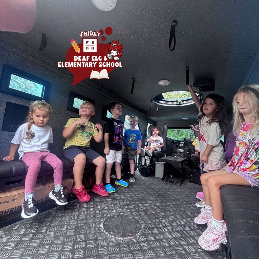 ELC students sit inside the police truck. 