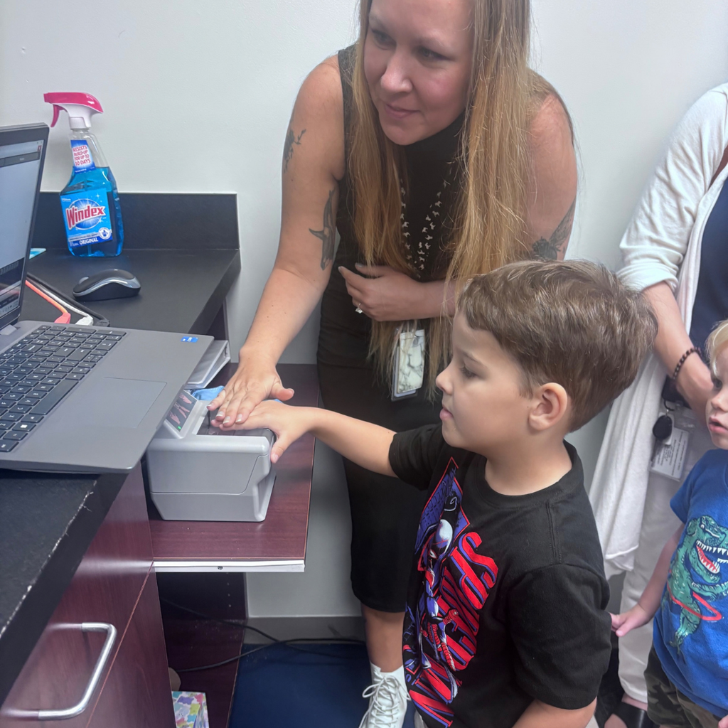 ELC student getting his fingerprint done inside the police building.
