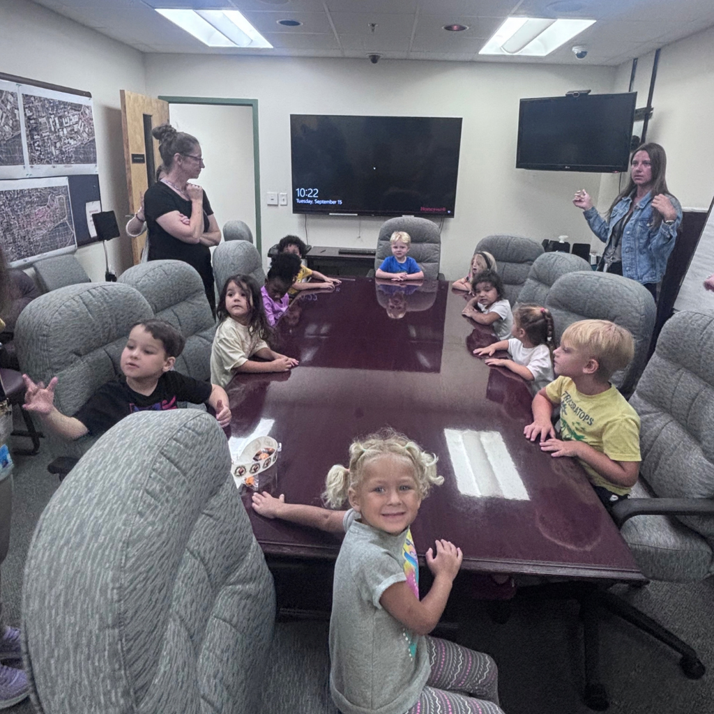 Group of ELC students sit inside the conference room inside the campus police building.