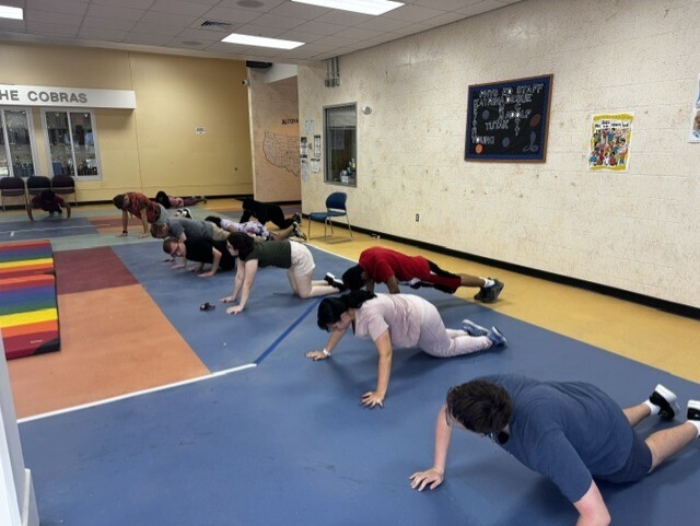 Students doing push ups in Copeland lobby.