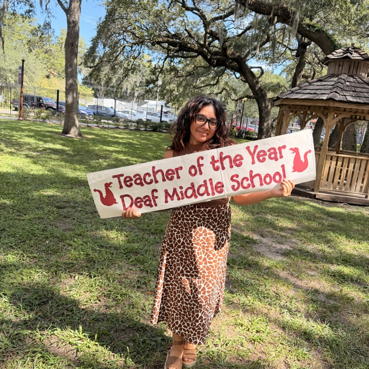 Alicia holding the Teacher of the Year banner