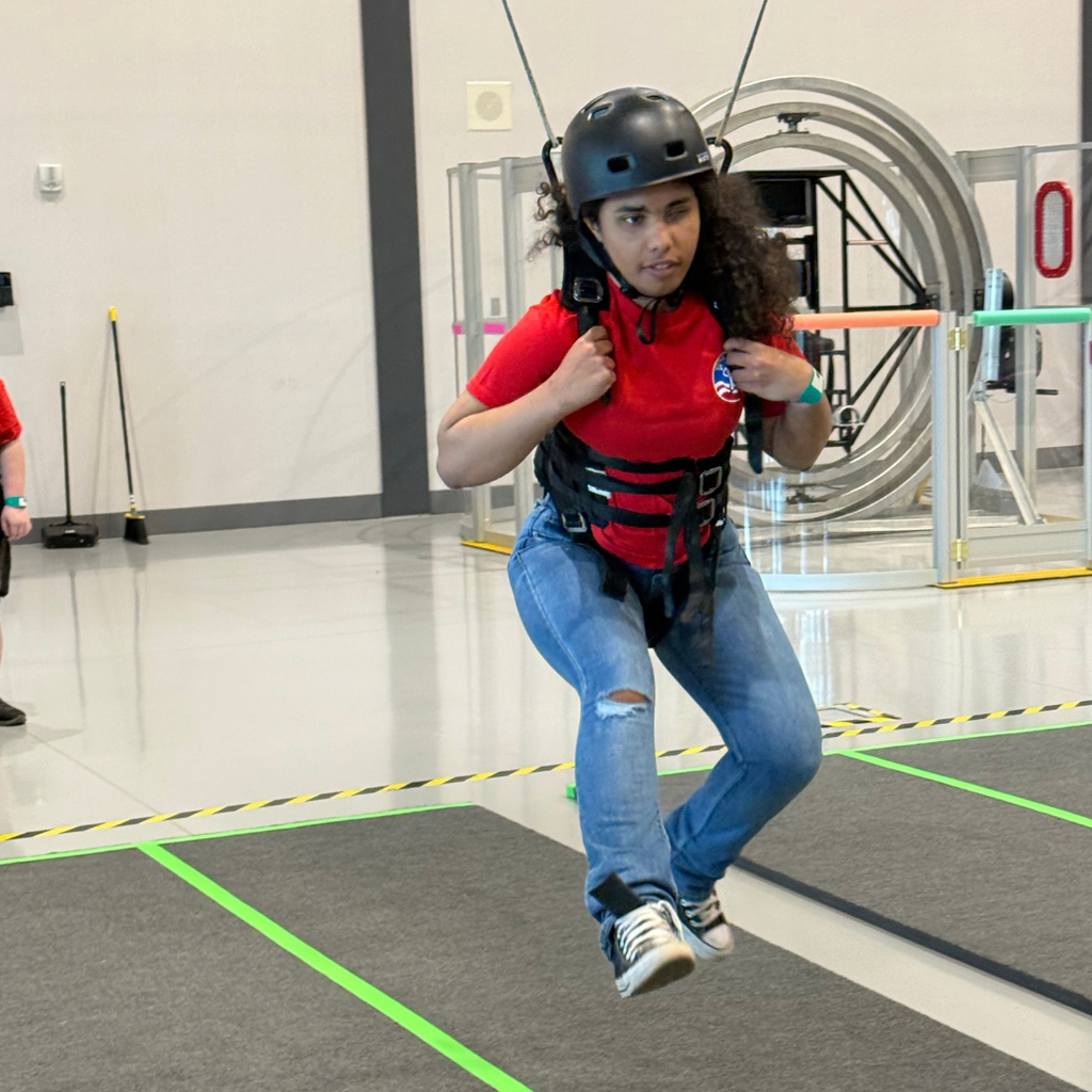 A student in a harness practicing flying.