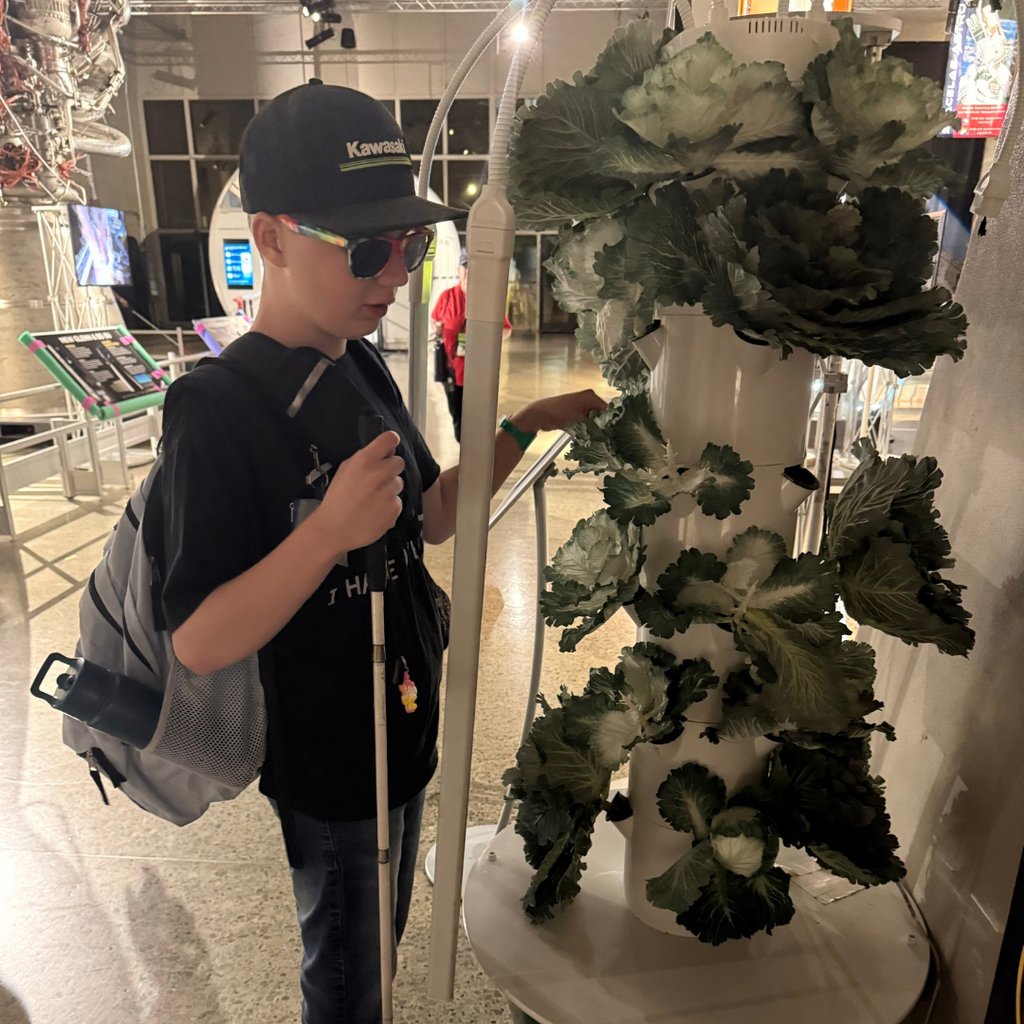 A student touching a sculpture.