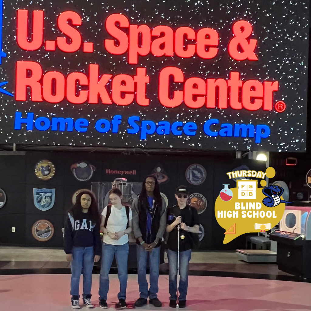 Group of students smile for a photo by the "US Space & Rocket Center, Home of Space Camp" sign.
