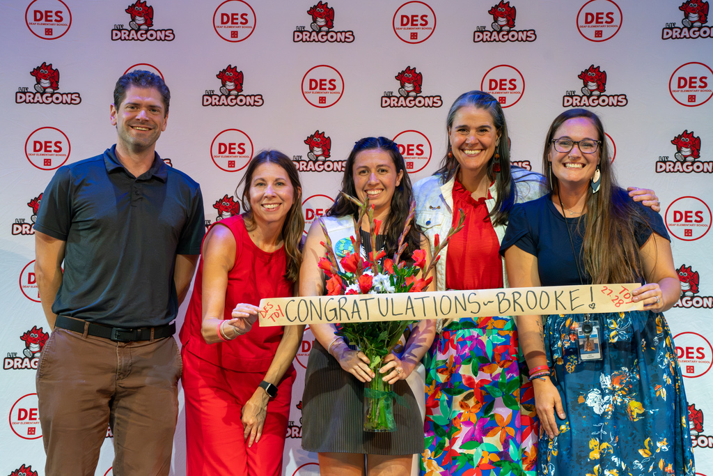 Left to Right: Deaf Principal, Assistant Principal of DES, Brooke, President Tracie Snow and 2026-2027 TOY winner smile for a photo together on stage in Kirk. 