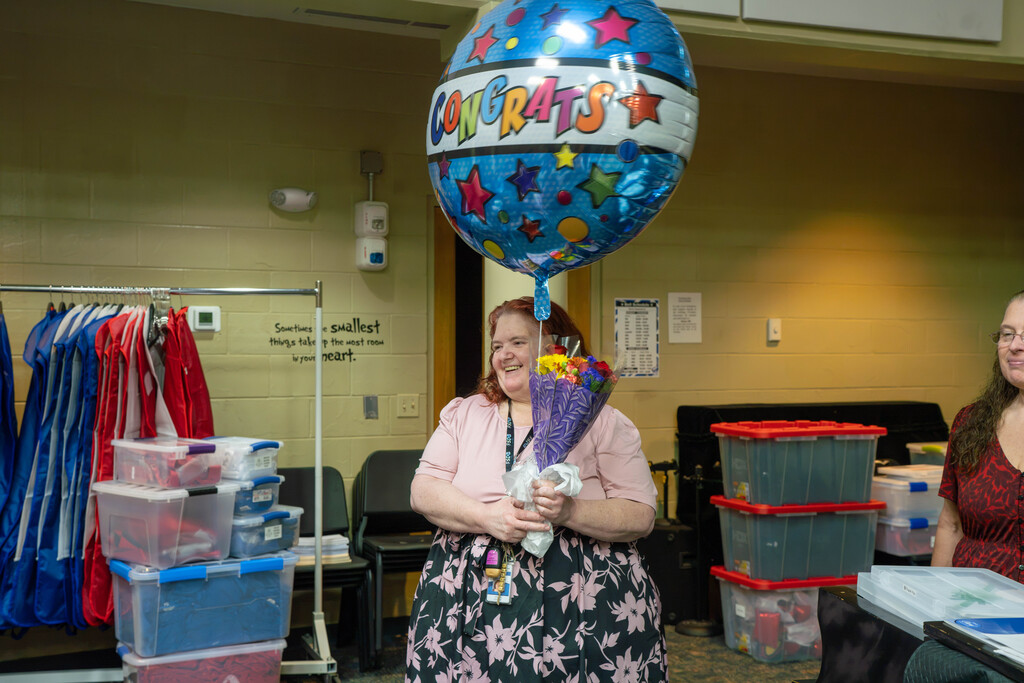 Leslie receiving flowers and a balloon. 