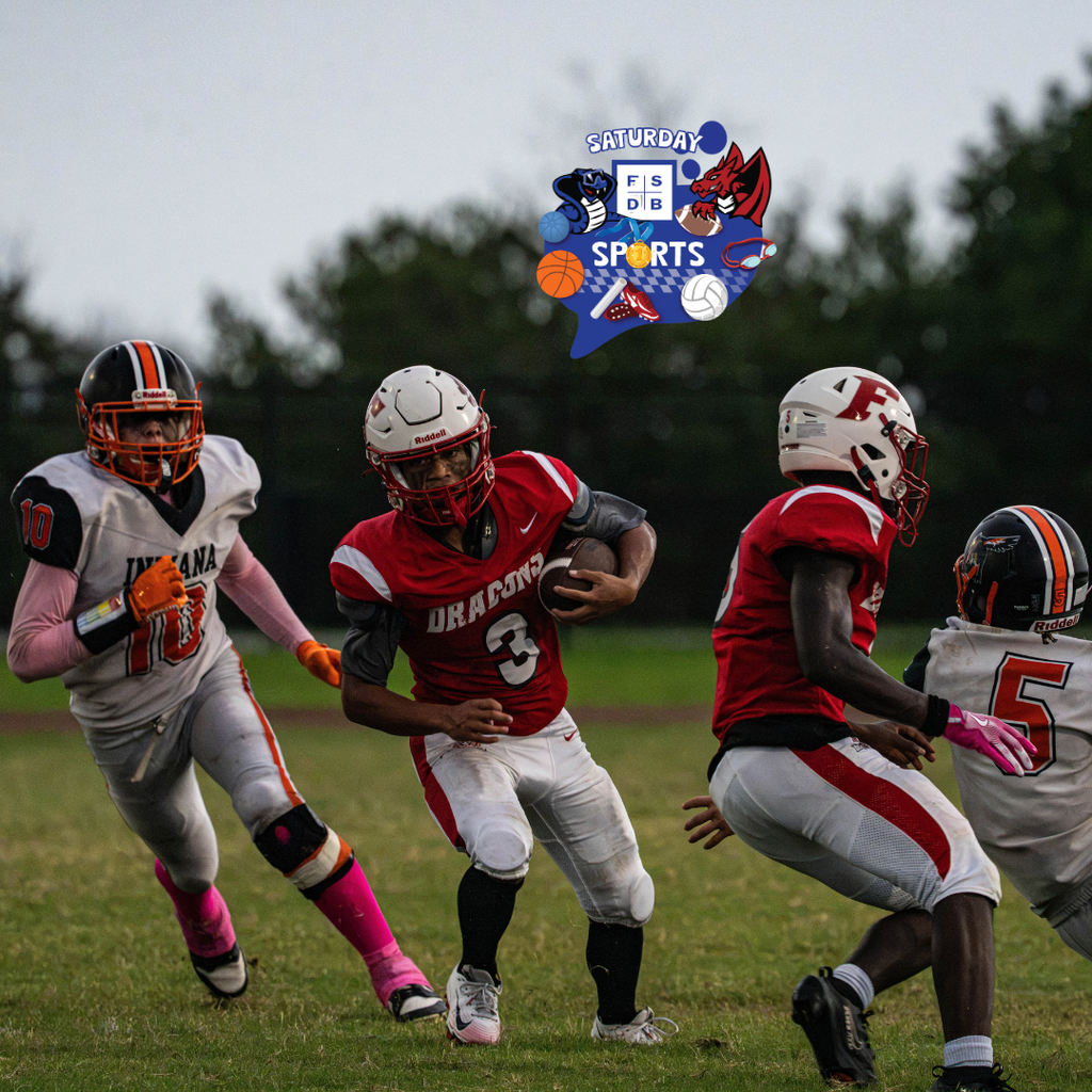 FSDB football player runs with the ball with ISD player chasing after him. 
