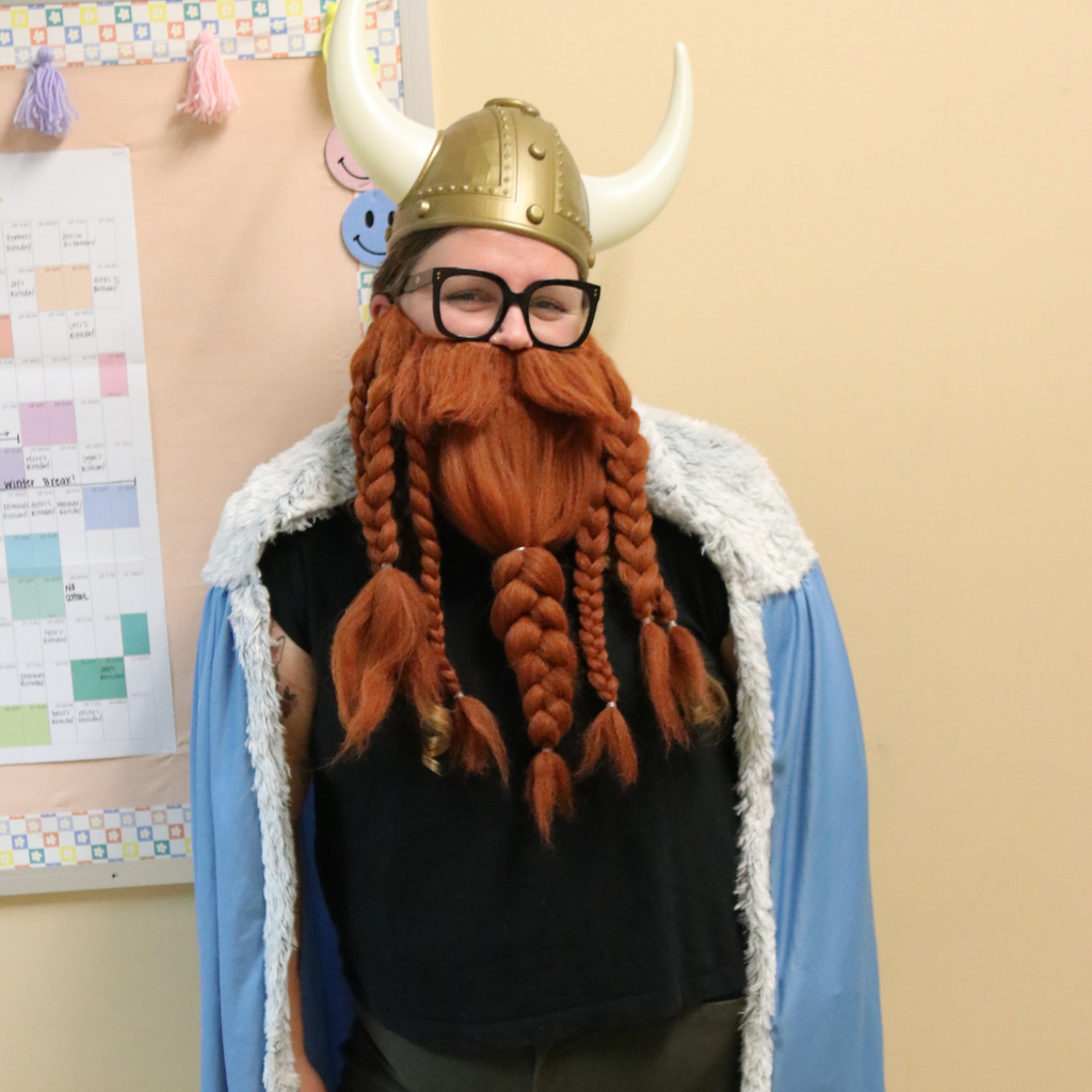 A teacher is dressed like a viking pose for her photo.