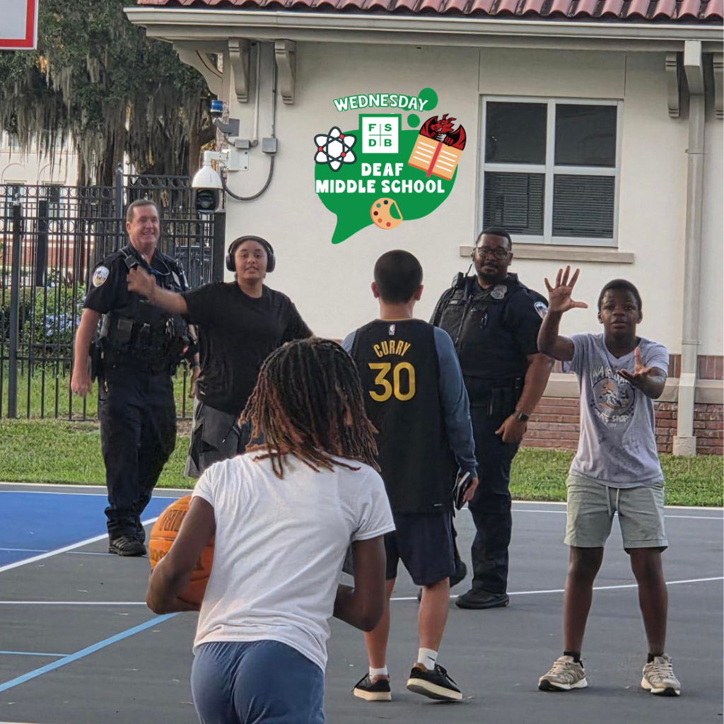 Group of dorm students play basketball with the cops. 