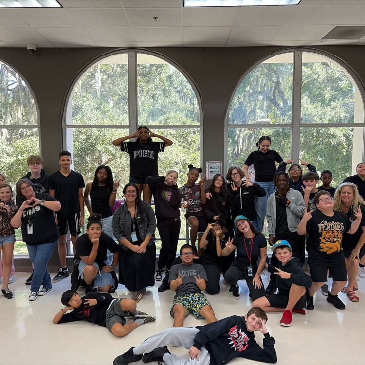 group is students in the cafeteria all wearing black