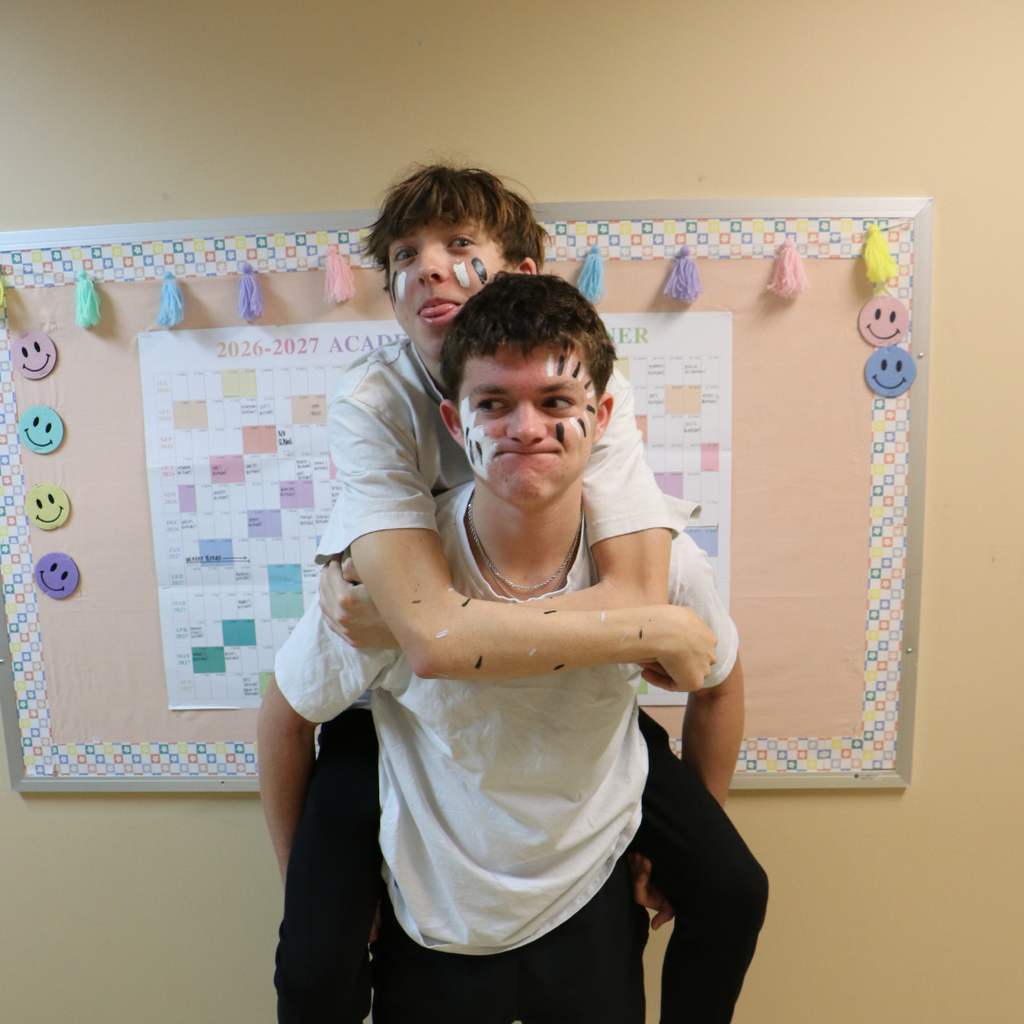 Two students dressed in white and black.
