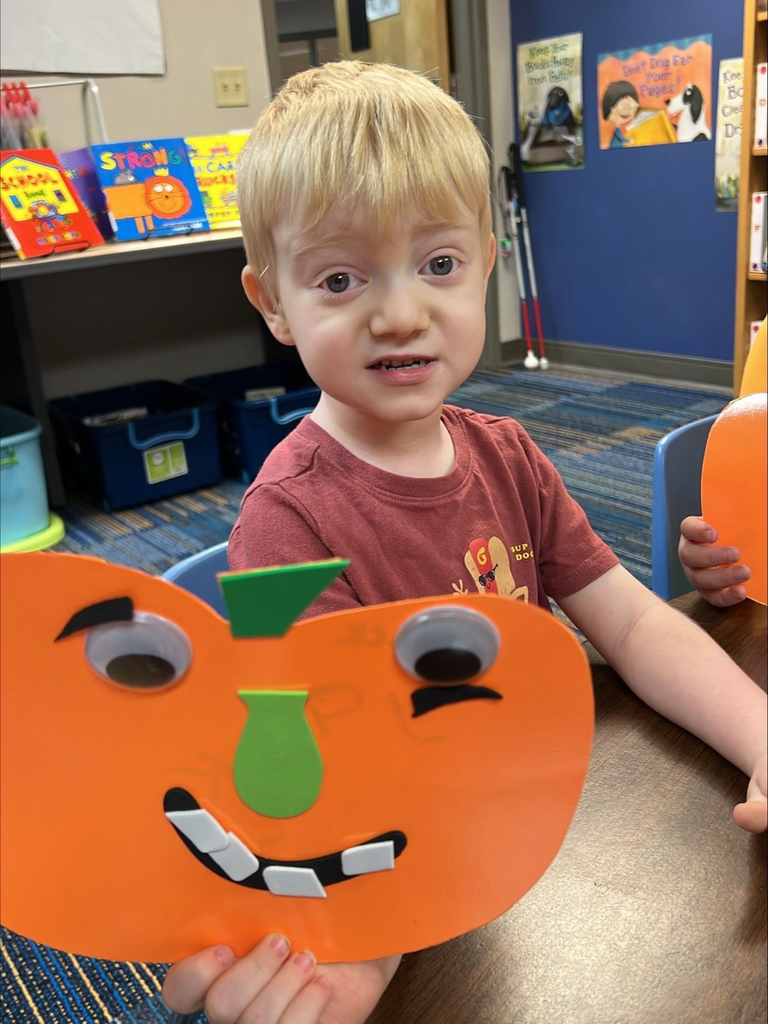 Jack smiles with his pumpkin he created. 