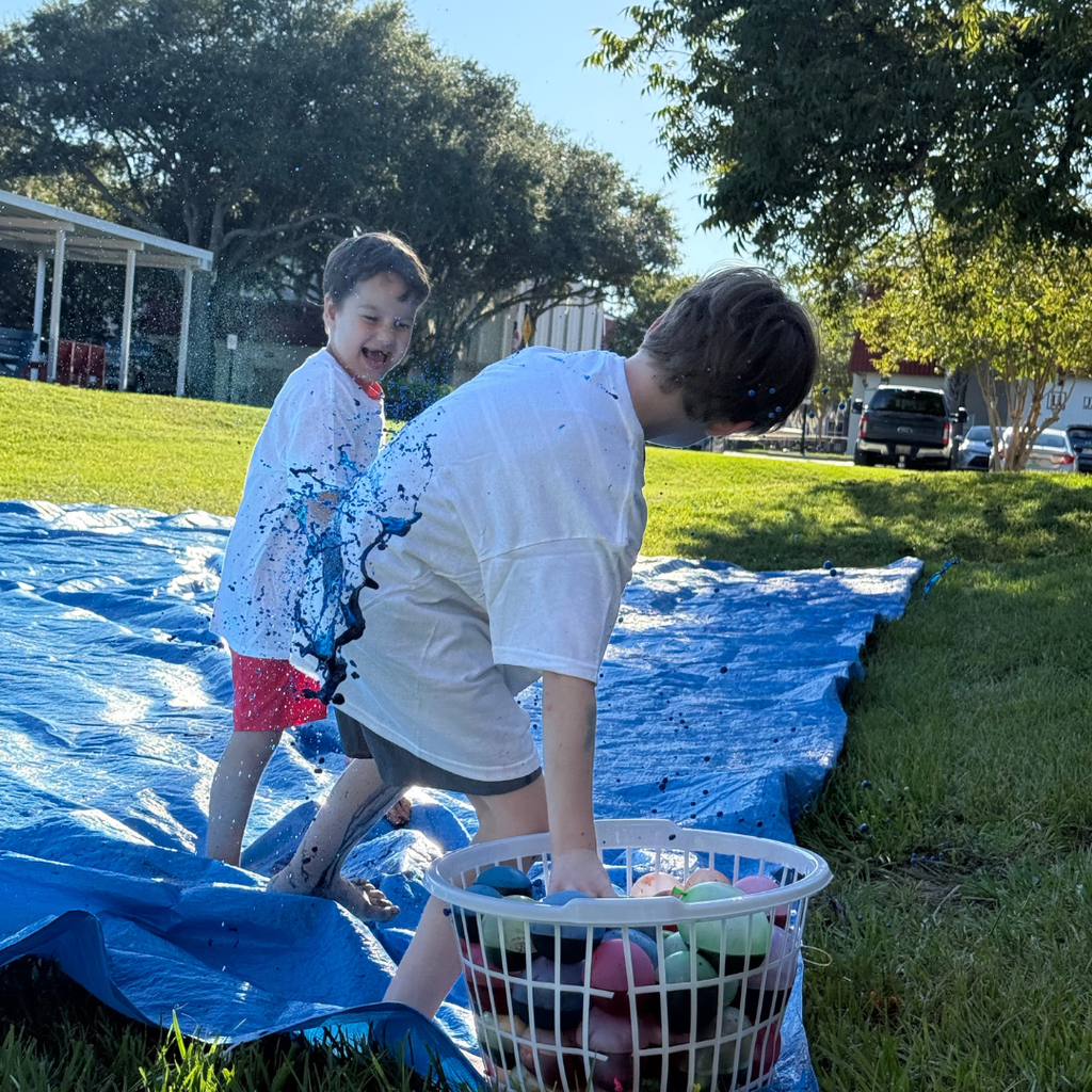 Two students throw the balloons at each other. 