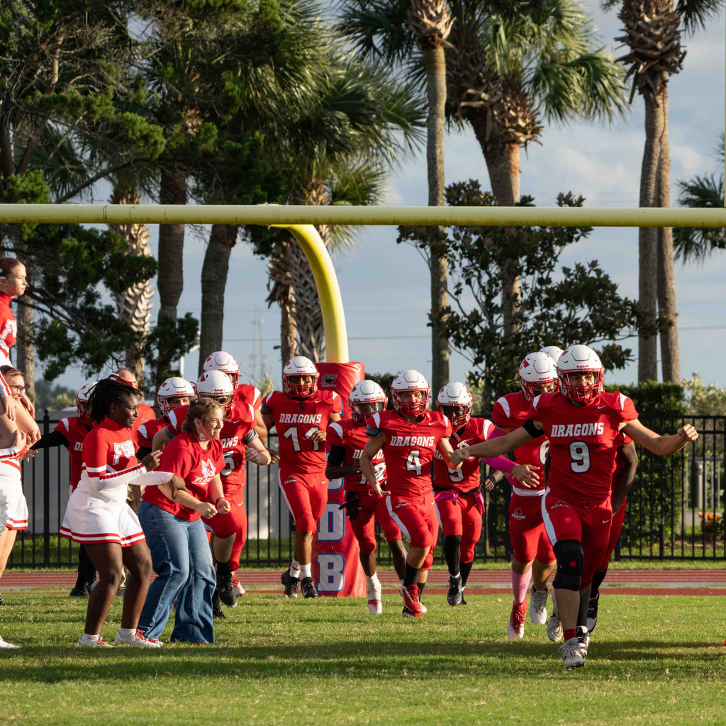FSDB football team run through the cheerleaders on the field before the start of the game. 