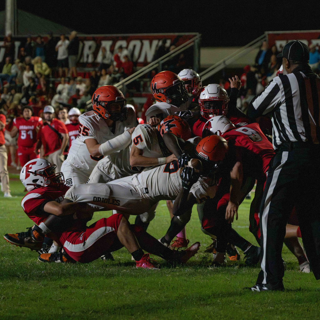FSDB and MSD on the field tackling who has the ball. 