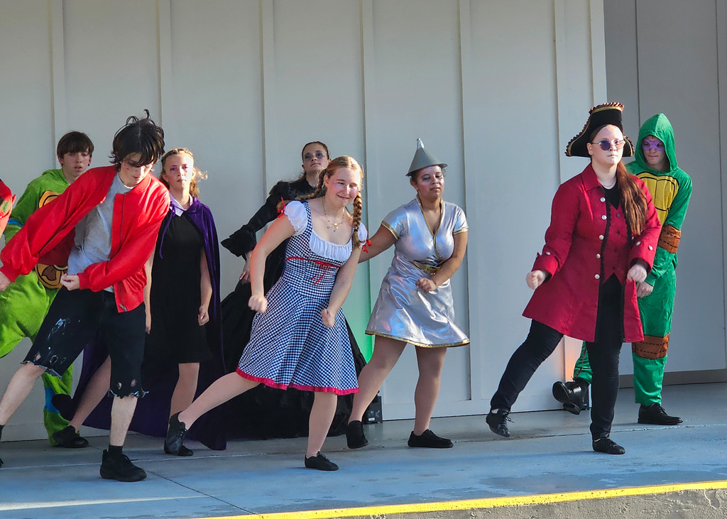 Group of Dance Troupe performers dressed in costumes dance at Kids Town. 