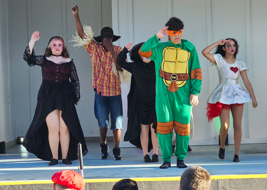 Dance Troupe performers dance on stage at Kids Town. 