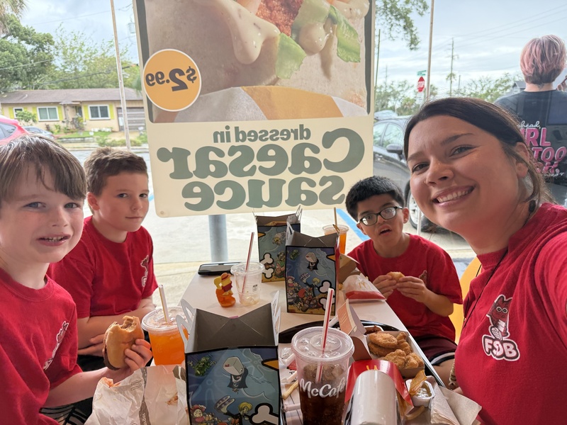 3 boys and a residential instructor eating at McDonalds.