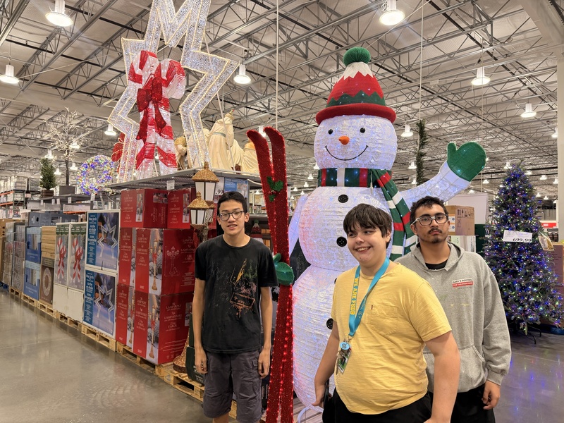 Students posing infront of Christmas decor in Costco