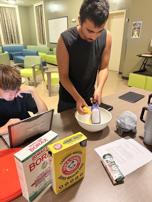 Student mixing ingredients to make laundry detergent