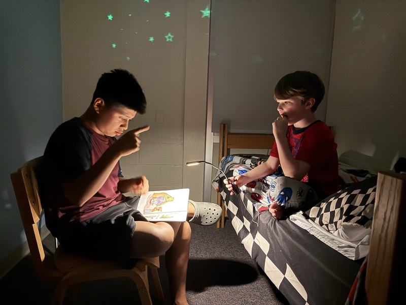 Irineo is reading a night time story to Colton