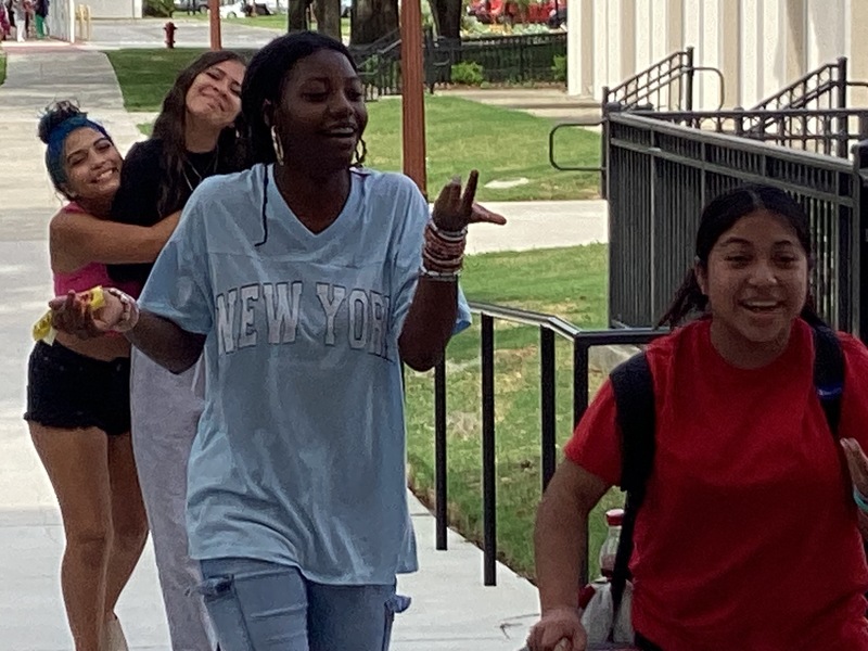 Girls walking into Gregg Hall