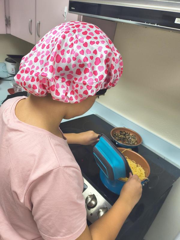 Girl cooking pasta.