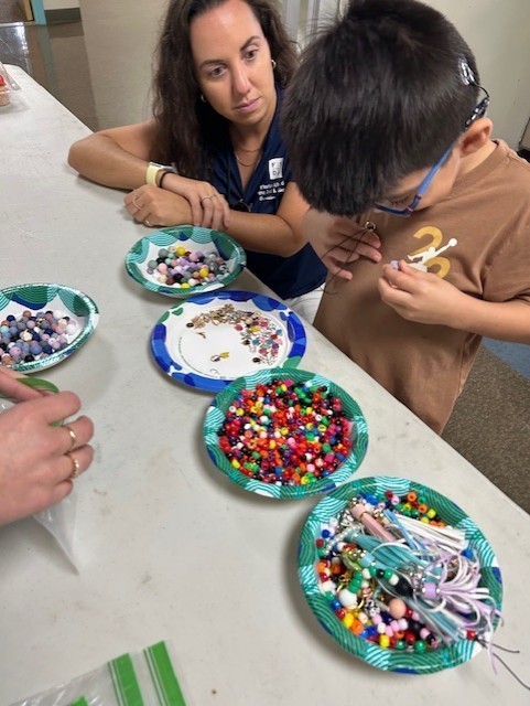 A boy decorating his cupcake.