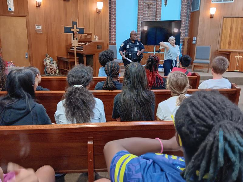 Girls listening to a presentation in the Chapel given by Campus Police.