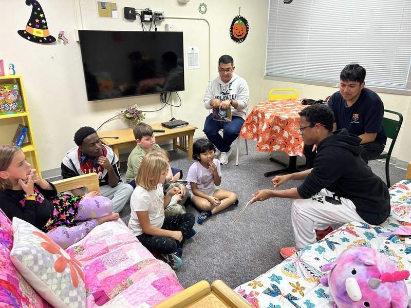 Boys signing to elementary students.