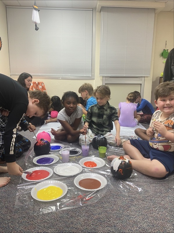 Students painting pumpkins.