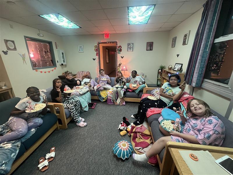 Watching a movie and enjoying popcorn.